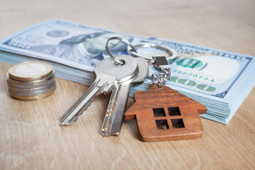 Real estate investing concept. American dollar, cash or housing. Keys close-up