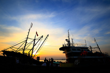 Fishing boats silhouetted against the setting sun