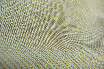 golden brocade silk fabric natural canvas texture background close-up