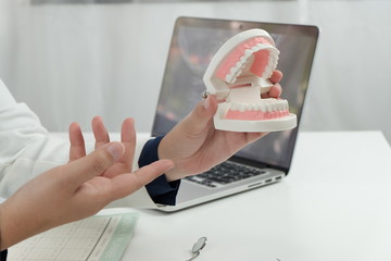 Dentist examining a patient teeth medical treatment at the dental office. 