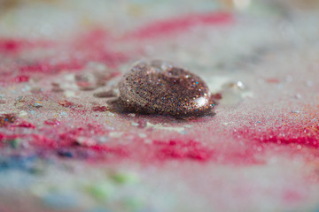 Beautiful colorful bubble with glitter inside leaved on a dirty table