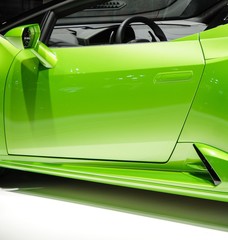 Shiny light green convertible sports car body door and rear view mirror