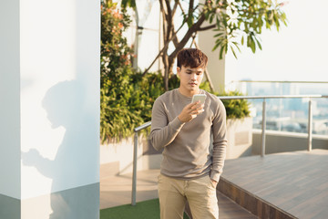 A man stading isolated and using phone