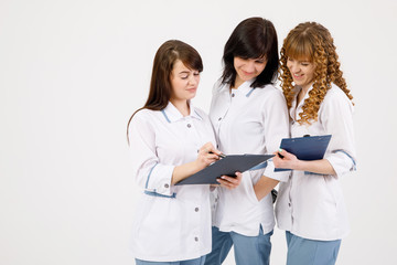 Professional doctor working in hospital office with nurses. Medical technology research institute and doctor staff service concept