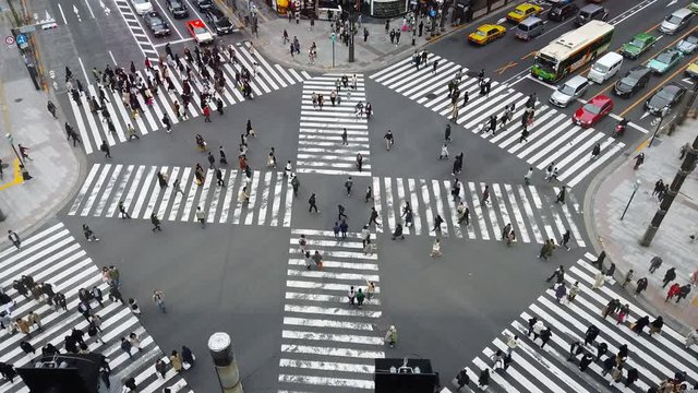 TOKYO,JAPAN-MARCH 30,2019:People passing the street crossing in Ginza district, Tokyo. Crosswalk. Intersection in Tokyo,Japan