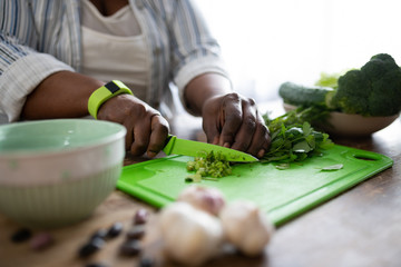 Close up of female hands that cutting parsley