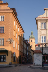 Street in Stare Miasto, Poland's capital Warshaw Old Town during sunrise. The tower of St. Martin's Church.