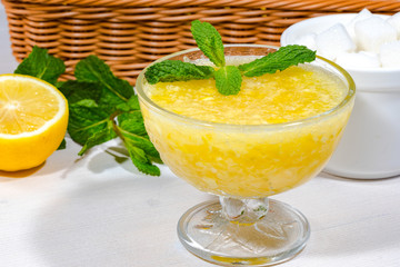 lemon jam with mint on a bright wood table. close up