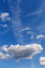 Beautiful blue sky with white cumulus and cirrus clouds as a natural background