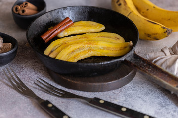Fried bananas in frying pan. Cinnamon dusted plantains pan fried in butter is a popular dessert in Mexico and other South Latin American countries.