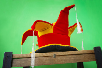 Jester's hat on green background. Fun joker's cap.