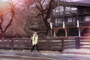 Young woman walks in the autumn mountain city