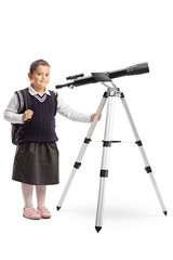 Little girl in a school uniform with a telescope