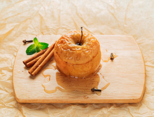 Apple baked with honey and cinnamon on burlap