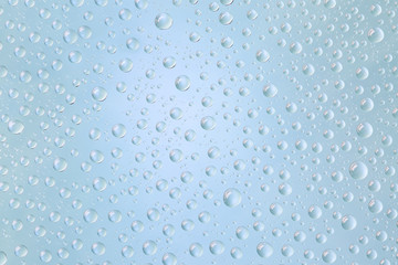 Beautiful water droplets of regular shape on frosted glass