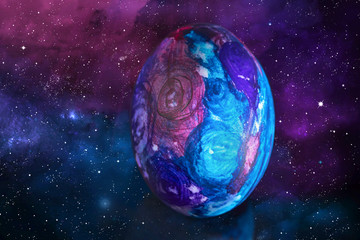 Naklejka na ściany i meble Easter egg in space style. Easter egg in space style on the background of the starry sky and the galaxy.