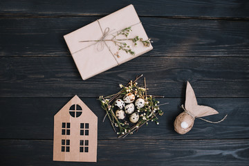 Rustic easter still life with quail eggs, dry willow branches on dark background. Flat lay, top view