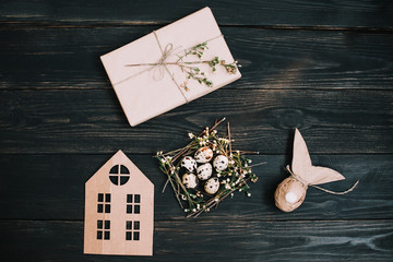 Rustic easter still life with quail eggs, dry willow branches on dark background. Flat lay, top view