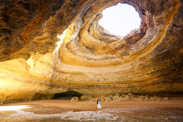 Beautiful wedding couple posing in the caves of Benagil