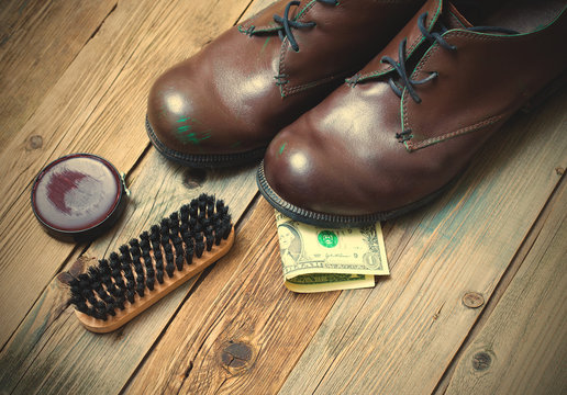boots, brush, shoe polish and dollar