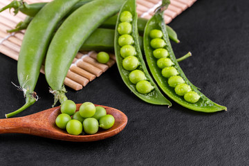 Sugar snap peas with mint on a rustic wood background