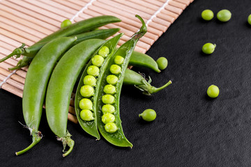 Sugar snap peas with mint on a rustic wood background