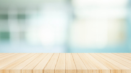 Wood table top on  with blur glass window wall background. For montage product display or design...