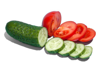 Ripe green cucumber and red tomato on white background. Healthy eating and dieting concept.