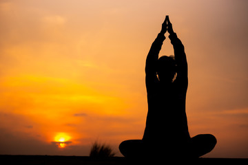 YOGA Silhouette woman sitting area meditating in sunset - Image