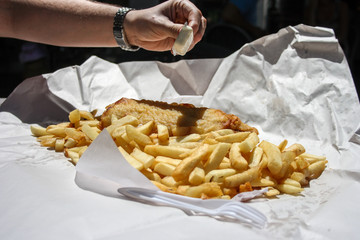 Takeaway fish and chips meal, served on a paper with a plastic fork, Australia