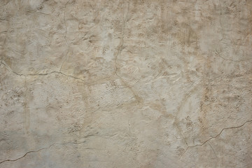 Old rough gray wall with a crack on plaster.  Structured Grunge Textured Background