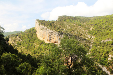 A wooden staircase at rock cliff as part of hiking path in Mont Rebei canyon, Spain