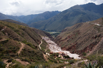 Panoramic view on the pools of the Salinas de Maras, Peruvian famous and traditional salt mine near...