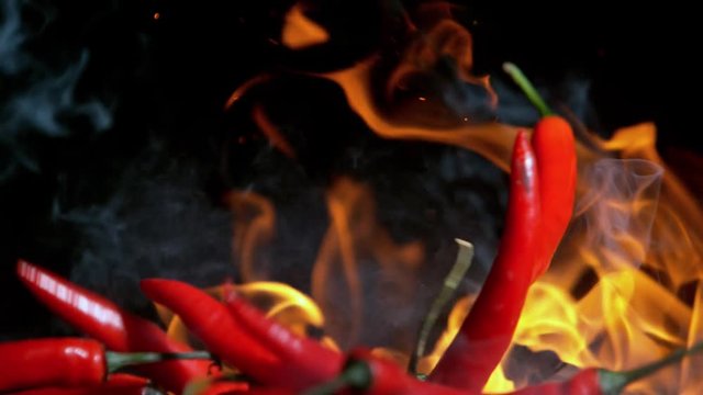 Super Slow Motion Shot of Falling Red Chilli Peppers to fire at 1000fps.
