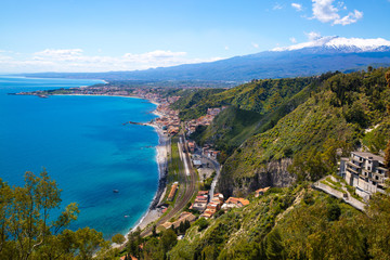 Scenic view of Etna volcano and blue Mediterranean sea (Ionian sea) from Taormina, Sicily island, Italy.