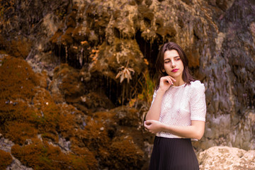 Naklejka na ściany i meble Beautiful girl posing in river, fairy fast forest in autumn. Beauty, fashion. Spa, healthcare. Tropical vacation. Natural pool.