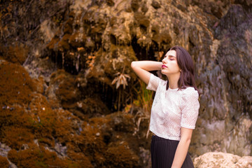 Beautiful girl posing in river, fairy fast forest in autumn.  Beauty, fashion. Spa, healthcare. Tropical vacation. Natural pool.