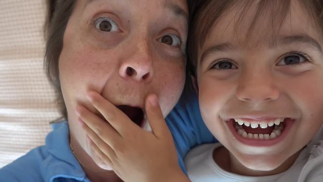 4K Selfie Small son with his hand closes mouth of his yelling mother