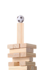 tower made with wooden blocks  with a foot ball on the top isolated on white background with clipping path and copy space for your text