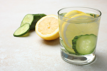 cup of  water with lemon and cucumber
