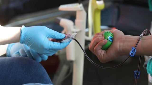 Blood Donation, Nurse receiving blood from blood donor in hospital. Blood tests to check your health before work, Nurse Working with Blood Donor at Hospital, Blood Plasma Fractionation, Squeezing Stre