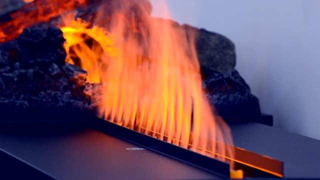 Artificial electrofireplace glowing backlight close-up.