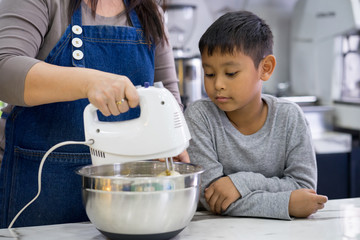 Mother and son making a cake