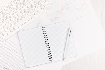 Flat lay photo of white office desk with laptop, smartphone, eyeglasses, notebook and pen with copy space background. Mockup