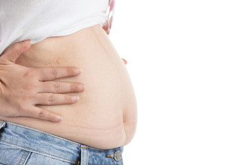 Overweight woman in jeans and fat on hips and belly isolated on white background.