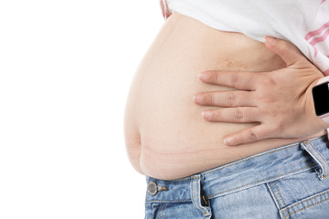 Overweight woman in jeans and fat on hips and belly isolated on white background.