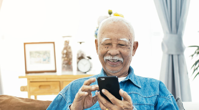 Asian Senior Man With White Mustache Talking With Smart Phone.