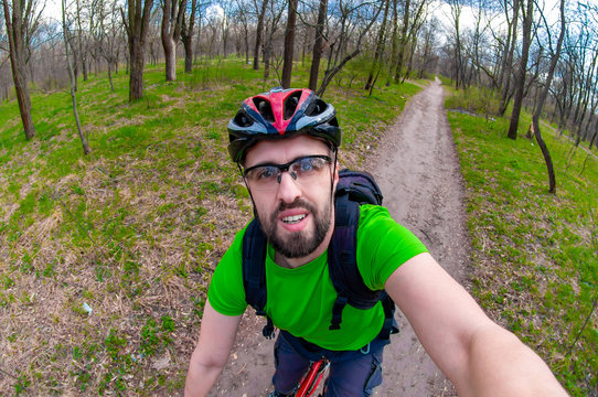 Sports cyclist makes selfie while riding a bike