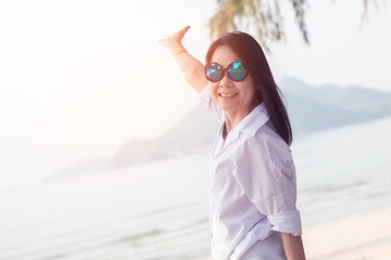 Asian smile woman at the beach enjoying in summer holidays