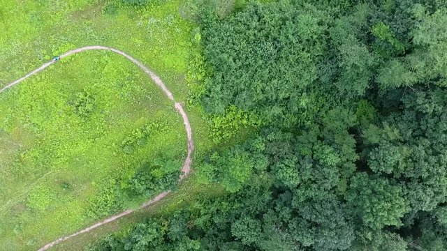 View from the air on a motorcyclist who trains on a rural homemade track